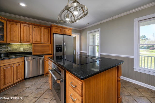 kitchen featuring a kitchen island, stainless steel appliances, backsplash, light tile floors, and sink