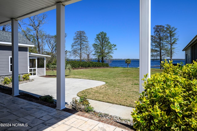 view of yard featuring a patio and a water view