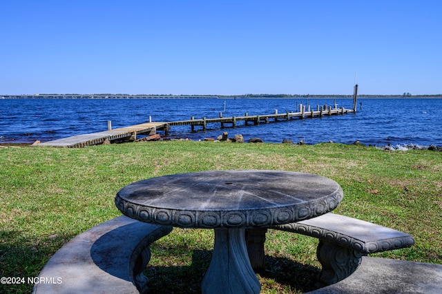 dock area featuring a yard and a water view