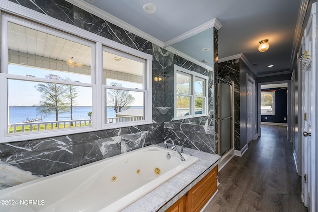 bathroom featuring a water view, ornamental molding, plenty of natural light, and hardwood / wood-style flooring