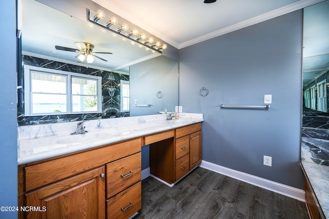 bathroom featuring double sink, oversized vanity, crown molding, wood-type flooring, and ceiling fan