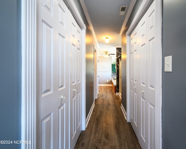 hall with crown molding and dark hardwood / wood-style flooring