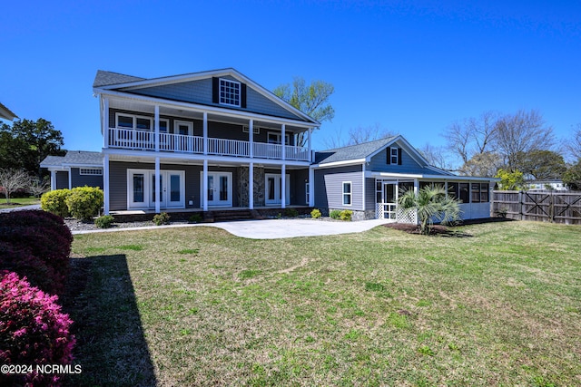 rear view of house featuring a lawn