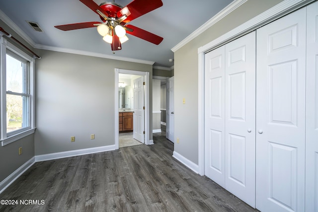 unfurnished bedroom with ensuite bathroom, crown molding, ceiling fan, and dark hardwood / wood-style flooring