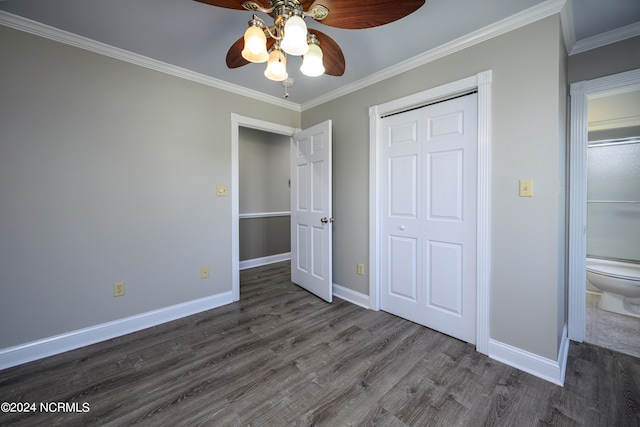 unfurnished bedroom featuring a closet, crown molding, dark hardwood / wood-style floors, and ceiling fan