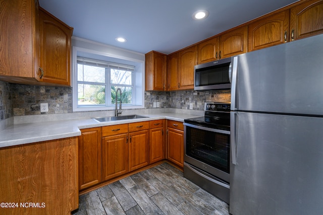 kitchen featuring tasteful backsplash, appliances with stainless steel finishes, dark hardwood / wood-style floors, and sink