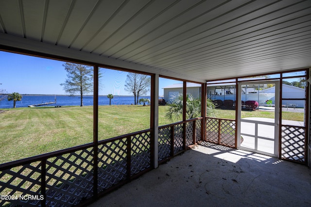 unfurnished sunroom featuring lofted ceiling and a water view