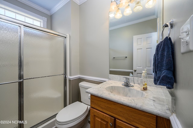 bathroom with walk in shower, ornamental molding, toilet, and vanity with extensive cabinet space