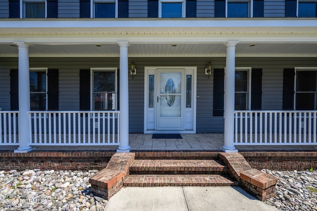 doorway to property with a porch