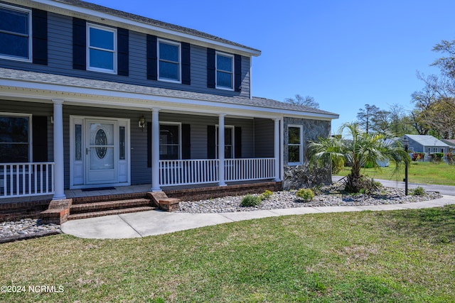 farmhouse with a front lawn and a porch