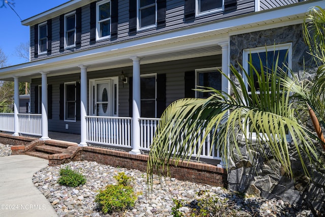 property entrance with covered porch