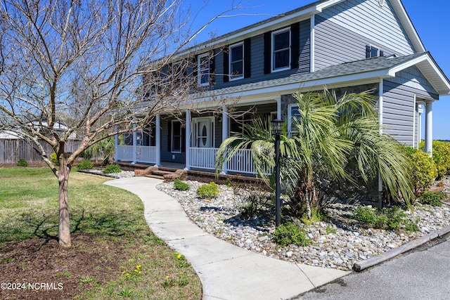 view of front of property featuring a front yard and covered porch