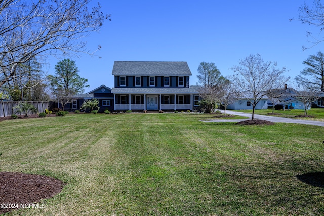 colonial inspired home with a front lawn