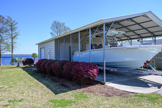 view of vehicle parking featuring a lawn, a water view, and a carport