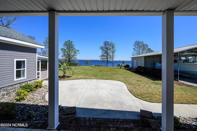 view of patio with a water view and a carport