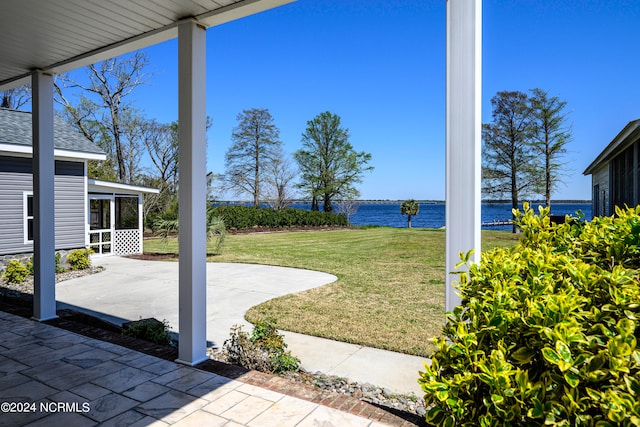 view of yard with a patio and a water view