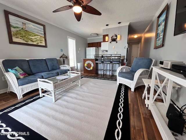 living room with a textured ceiling, ceiling fan, and dark wood-type flooring