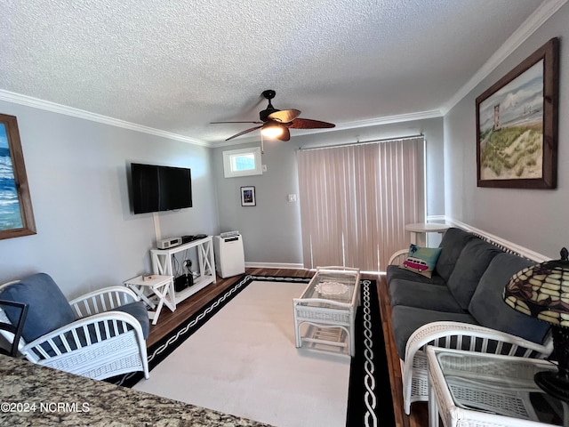 living room featuring wood-type flooring, ceiling fan, crown molding, and a textured ceiling