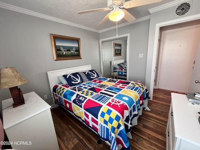 bedroom with ceiling fan, crown molding, a textured ceiling, a closet, and dark hardwood / wood-style flooring