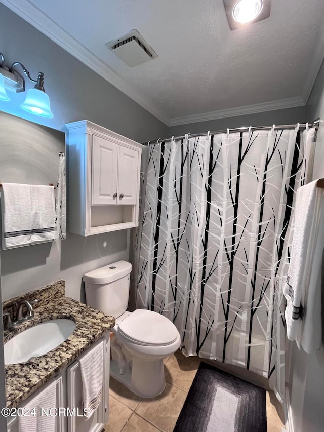 bathroom featuring tile flooring, crown molding, vanity, and toilet