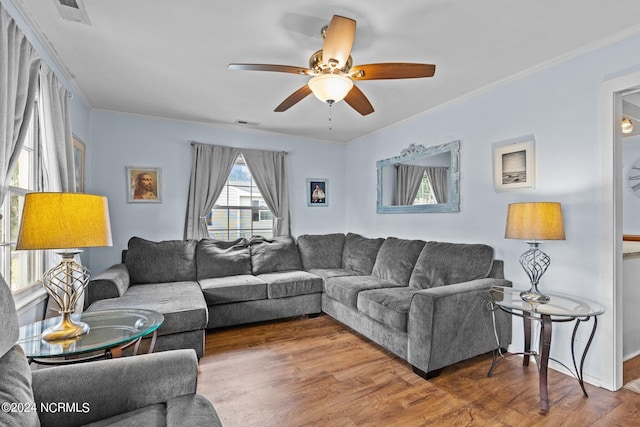 living room featuring crown molding, dark hardwood / wood-style floors, and ceiling fan