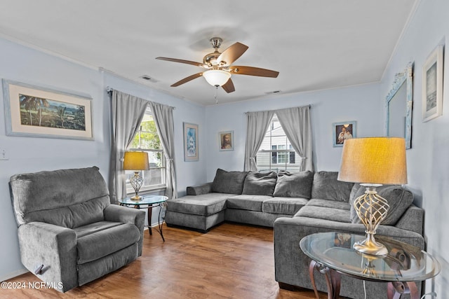 living room featuring ceiling fan, ornamental molding, and hardwood / wood-style floors