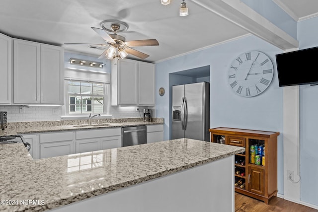 kitchen with light wood-type flooring, ceiling fan, stainless steel appliances, sink, and white cabinets