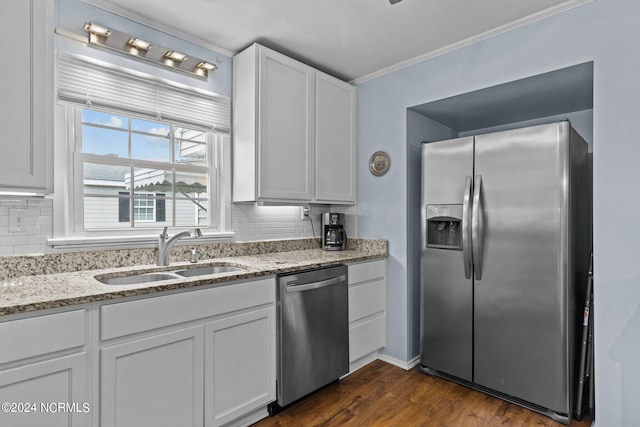 kitchen featuring stainless steel appliances, white cabinets, backsplash, dark hardwood / wood-style floors, and sink