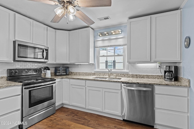 kitchen with ceiling fan, stainless steel appliances, sink, dark hardwood / wood-style floors, and white cabinets