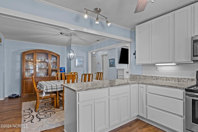 kitchen with stainless steel appliances, backsplash, dark wood-type flooring, and white cabinetry