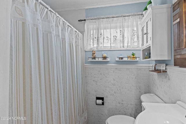 bathroom with toilet and tile walls