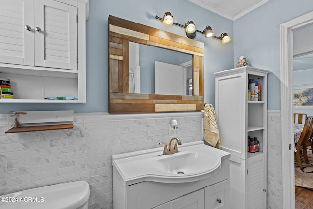 bathroom featuring oversized vanity, toilet, ornamental molding, and wood-type flooring