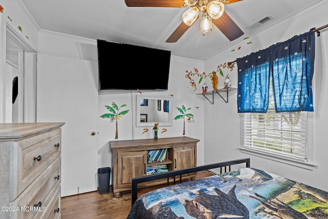 bedroom featuring dark hardwood / wood-style flooring, ceiling fan, and ornamental molding