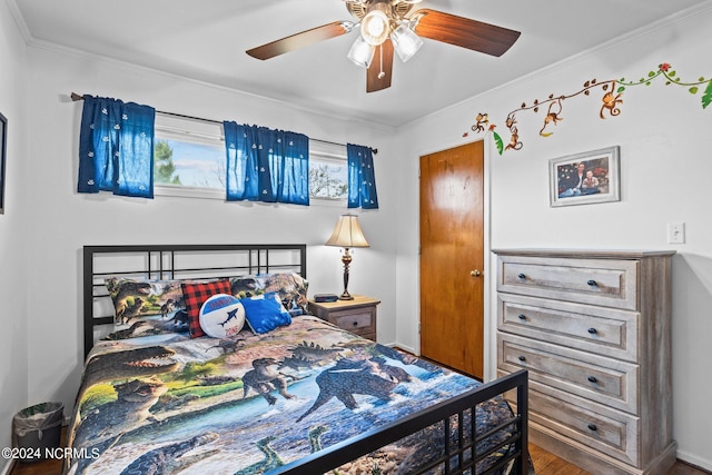 bedroom with ceiling fan, ornamental molding, and wood-type flooring