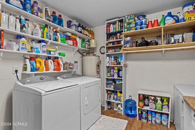 washroom with washer and dryer, light wood-type flooring, and water heater