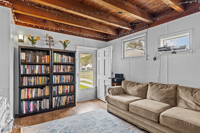 living room featuring light hardwood / wood-style floors, wooden ceiling, and beamed ceiling