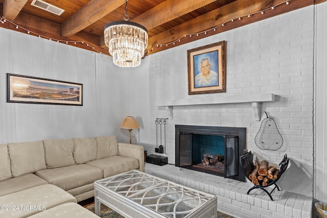 living room with a brick fireplace, wood ceiling, a notable chandelier, and beamed ceiling