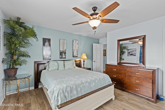 bedroom featuring ceiling fan and light hardwood / wood-style flooring