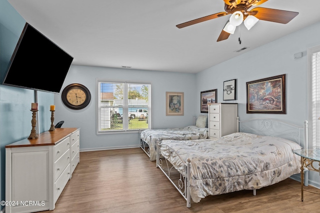 bedroom with light hardwood / wood-style floors and ceiling fan