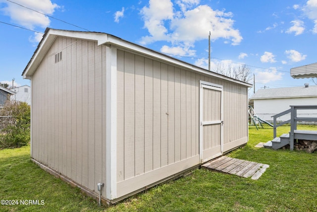 view of shed / structure featuring a yard