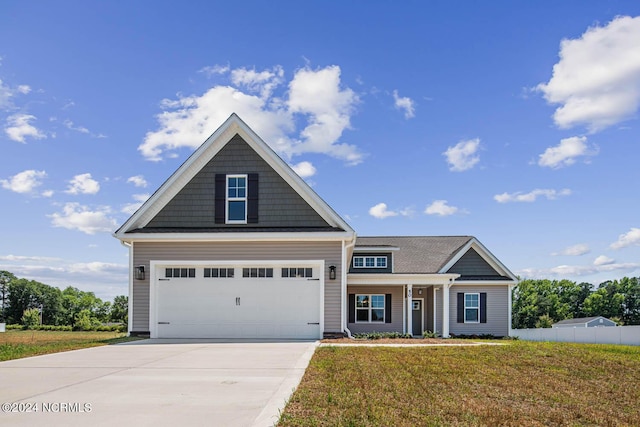 craftsman-style house with a garage and a front lawn