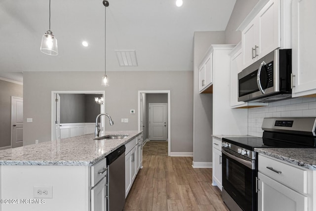 kitchen featuring stainless steel appliances, sink, pendant lighting, and white cabinets