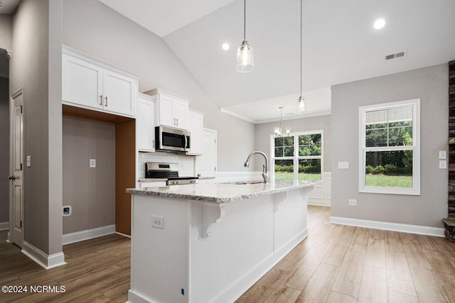 kitchen with sink, white cabinetry, decorative light fixtures, a center island with sink, and stainless steel appliances