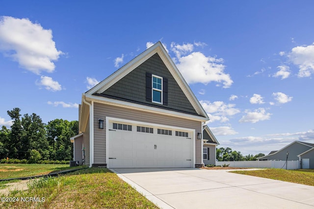 view of property exterior featuring a garage and a lawn