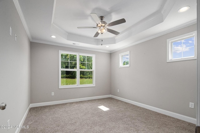 unfurnished room with crown molding, carpet flooring, a tray ceiling, and ceiling fan