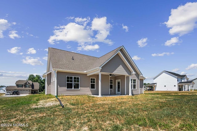 back of house with a lawn