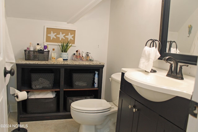 bathroom featuring toilet, vanity with extensive cabinet space, tile flooring, and ornamental molding