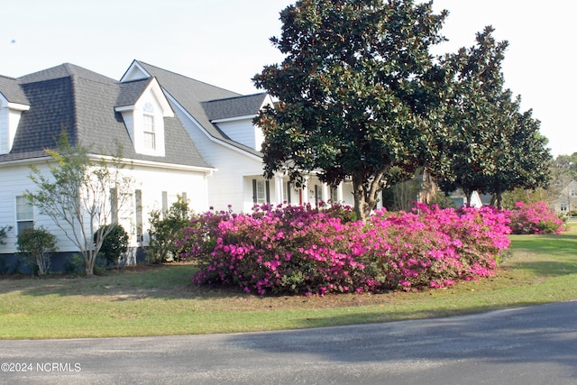 view of side of property with a yard