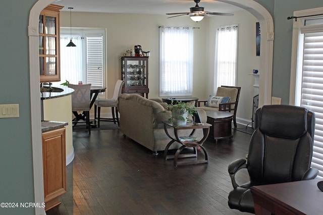 living room featuring dark hardwood / wood-style floors and ceiling fan