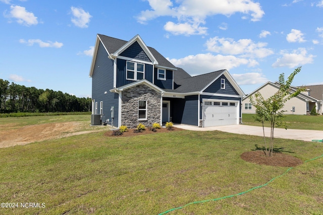 craftsman-style house with concrete driveway, central AC unit, a garage, stone siding, and a front lawn